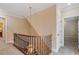 Upper staircase landing with carpet, iron railings, and a decorative chandelier at 3605 Camp Mangum Wynd, Raleigh, NC 27612