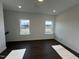 A brightly lit bonus room with two windows and dark wood flooring at 4301 Darius Lane # 28, Fuquay Varina, NC 27526