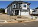 Two-story gray home featuring a two-car garage, stone accents, and a well-manicured lawn at 4301 Darius Lane # 28, Fuquay Varina, NC 27526