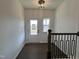Bright foyer with dark hardwood floors, white walls, staircase, and a view of the front door at 4301 Darius Lane # 28, Fuquay Varina, NC 27526