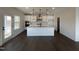 Open-concept kitchen featuring a large white island, modern appliances, and hardwood floors at 4301 Darius Lane # 28, Fuquay Varina, NC 27526