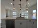 Bright kitchen island with quartz countertops and stainless steel dishwasher, open to the living area at 4301 Darius Lane # 28, Fuquay Varina, NC 27526