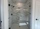 Luxurious walk-in shower with marble-style tiling, black hardware, and glass enclosure at 4301 Darius Lane # 28, Fuquay Varina, NC 27526