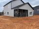 Rear view of the home featuring a covered patio area with black railings at 4309 Darius Ln # 26, Fuquay Varina, NC 27526