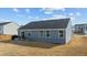 View of the home's rear exterior showing the patio and the expansive backyard at 45 Florentine Ct, Angier, NC 27501