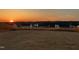 Large, fenced backyard with a beautiful sunset backdrop, offering plenty of space for recreation and relaxation at 45 Florentine Ct, Angier, NC 27501