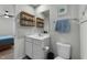 Bathroom with white vanity, toilet, mirror and open shelving for toiletries at 45 Florentine Ct, Angier, NC 27501