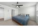 Bright bedroom features neutral walls, ceiling fan, carpet flooring, and en-suite bathroom at 45 Florentine Ct, Angier, NC 27501