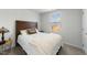 Comfortable bedroom with natural light, featuring neutral colors and a bed with throw blanket at 45 Florentine Ct, Angier, NC 27501