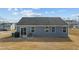 Home exterior featuring blue siding, a patio, and a sliding glass door leading to the backyard at 45 Florentine Ct, Angier, NC 27501