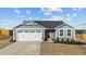Charming single-Gathering home with a well-maintained front yard, garage, and a vibrant red front door at 45 Florentine Ct, Angier, NC 27501