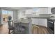 Open-concept kitchen with a central island, stainless steel appliances, and bar seating at 45 Florentine Ct, Angier, NC 27501