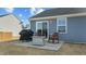 Cozy backyard patio area with grill, seating, and convenient access to the house through a sliding glass door at 45 Florentine Ct, Angier, NC 27501