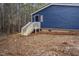 Charming home featuring navy blue siding, brick foundation, and a inviting wooden staircase entrance at 453 Deer Vw, Sanford, NC 27332