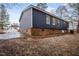 Home exterior showcasing navy siding, brick foundation, and a well maintained yard at 453 Deer Vw, Sanford, NC 27332