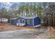 Picture of the blue home with the front entrance and driveway, with trees in the background at 453 Deer Vw, Sanford, NC 27332