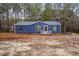 Charming blue home featuring black shutters, white trim, and a neatly maintained front yard at 453 Deer Vw, Sanford, NC 27332