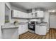 Well-lit kitchen features granite countertops, stainless steel appliances and sleek cabinets at 453 Deer Vw, Sanford, NC 27332