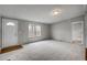 Inviting living room boasts two bright windows, neutral decor, and plush carpet for comfortable living at 453 Deer Vw, Sanford, NC 27332