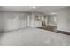 Spacious living room featuring modern gray walls and plush gray carpeted floors that flow into the kitchen area at 453 Deer Vw, Sanford, NC 27332