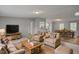 Inviting living room featuring cozy furniture and a dining area with a full sized wooden dining table at 453 Deer Vw, Sanford, NC 27332