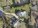 Aerial view of a home with a pool, long driveway, and well-maintained lawn and landscaping at 4709 Wyndchase Ct, Fuquay Varina, NC 27526