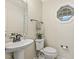 Half bathroom with a pedestal sink, octagonal window, and modern fixtures at 4709 Wyndchase Ct, Fuquay Varina, NC 27526