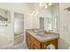 Bathroom vanity featuring double sinks, granite countertop, and updated fixtures at 4709 Wyndchase Ct, Fuquay Varina, NC 27526