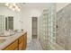 Bathroom with double vanity, glass block shower, and tiled flooring at 4709 Wyndchase Ct, Fuquay Varina, NC 27526