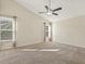 Spacious bedroom with plush carpet, high ceilings, and two sun-drenched windows at 4709 Wyndchase Ct, Fuquay Varina, NC 27526