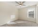Neutral bedroom featuring a ceiling fan, beige carpet, and a window with natural light at 4709 Wyndchase Ct, Fuquay Varina, NC 27526