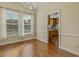 Dining area with hardwood floors, and large windows overlooking an in-ground pool and backyard at 4709 Wyndchase Ct, Fuquay Varina, NC 27526