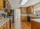 Spacious kitchen with wood cabinets, stone countertops, and stainless steel appliances at 4709 Wyndchase Ct, Fuquay Varina, NC 27526