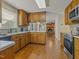 Traditional kitchen featuring wood cabinets, stainless steel appliances, and stone countertops at 4709 Wyndchase Ct, Fuquay Varina, NC 27526