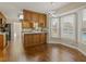 Bright eat-in kitchen area with views of pool, modern lighting, and wood cabinets at 4709 Wyndchase Ct, Fuquay Varina, NC 27526