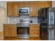 Kitchen area featuring wood cabinets, stainless steel appliances, and stone countertops at 4709 Wyndchase Ct, Fuquay Varina, NC 27526