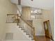 Living room featuring hardwood floors, staircase, a ceiling fan and a decorative front door at 4709 Wyndchase Ct, Fuquay Varina, NC 27526