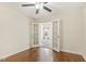Living room with hardwood floors, ceiling fan, and French doors to a bedroom at 4709 Wyndchase Ct, Fuquay Varina, NC 27526