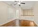 Hardwood flooring in a living area with ceiling fan and view of a staircase at 4709 Wyndchase Ct, Fuquay Varina, NC 27526