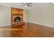 Inviting living room with brick fireplace, hardwood floors, and ceiling fan at 4709 Wyndchase Ct, Fuquay Varina, NC 27526