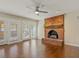 Inviting living room with a brick fireplace, hardwood floors, and French doors to the exterior at 4709 Wyndchase Ct, Fuquay Varina, NC 27526