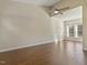 Sunlit living room featuring wood floors, a modern ceiling fan, and large windows at 4709 Wyndchase Ct, Fuquay Varina, NC 27526