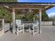 Outdoor bar area on a wood deck featuring a built in grill and two bar chairs at 4709 Wyndchase Ct, Fuquay Varina, NC 27526