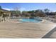 Outdoor pool with wooden deck and manicured greenery at 4709 Wyndchase Ct, Fuquay Varina, NC 27526