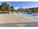 An in-ground swimming pool with a wooden deck and an outdoor bar and grill area at 4709 Wyndchase Ct, Fuquay Varina, NC 27526