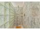 Shower features glass block wall, tile surround, and overhead shower head at 4709 Wyndchase Ct, Fuquay Varina, NC 27526