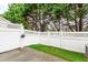 Back yard features a decorative fence and an area of artificial turf at 5117 Singing Wind Dr, Raleigh, NC 27612