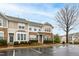 Inviting townhome featuring stone accents and manicured landscaping at 5117 Singing Wind Dr, Raleigh, NC 27612