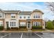 Charming townhome featuring stone accents, a landscaped front, and convenient parking at 5117 Singing Wind Dr, Raleigh, NC 27612