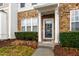 Charming front entrance with stone accents and a classic wreath at 5117 Singing Wind Dr, Raleigh, NC 27612